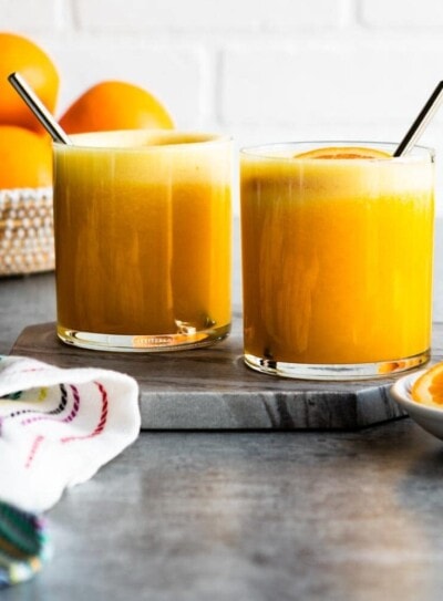 2 glasses of adrenal cocktail in short glasses with stainless steel straws.