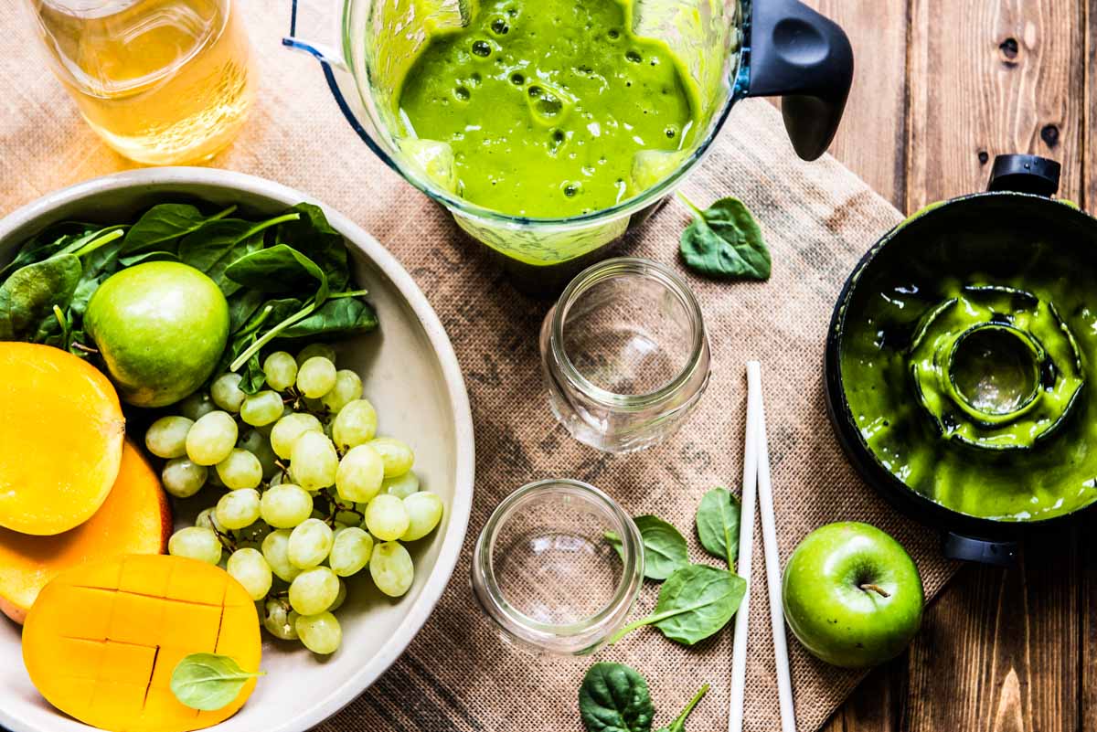 Blender lid on table with fresh smoothie ingredients