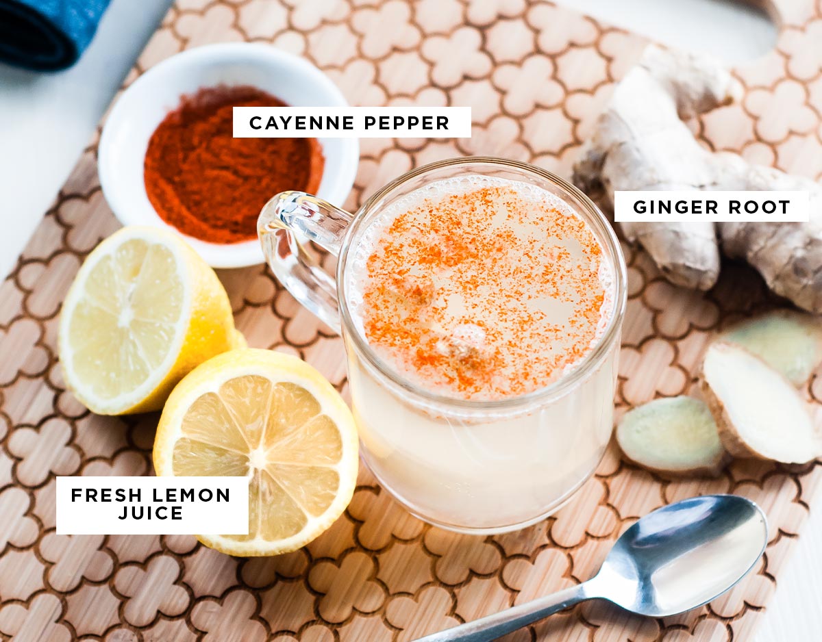 Labeled ingredients for the best detox tea recipe: cayenne pepper, ginger root, and fresh lemon juice.