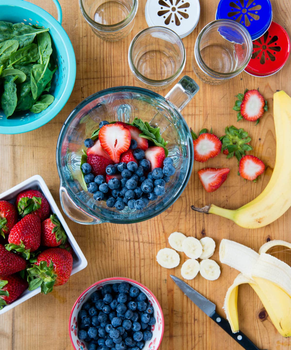 fruit and leafy greens in a blender container.