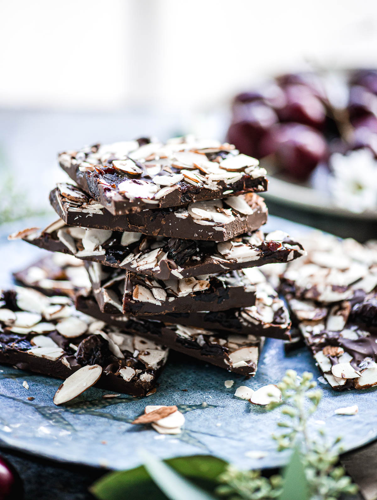 Pieces of cherry chocolate bark on a concrete table.