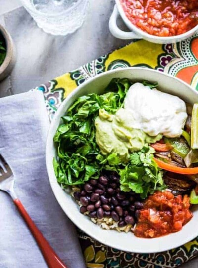 A colorful chipotle veggie bowl with a fork.