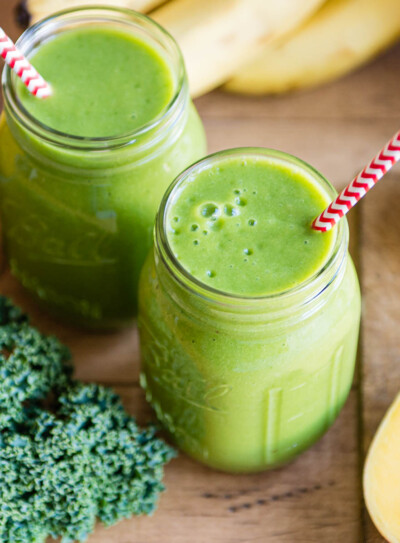 cleansing citrus smoothies in glass jars with paper straws.