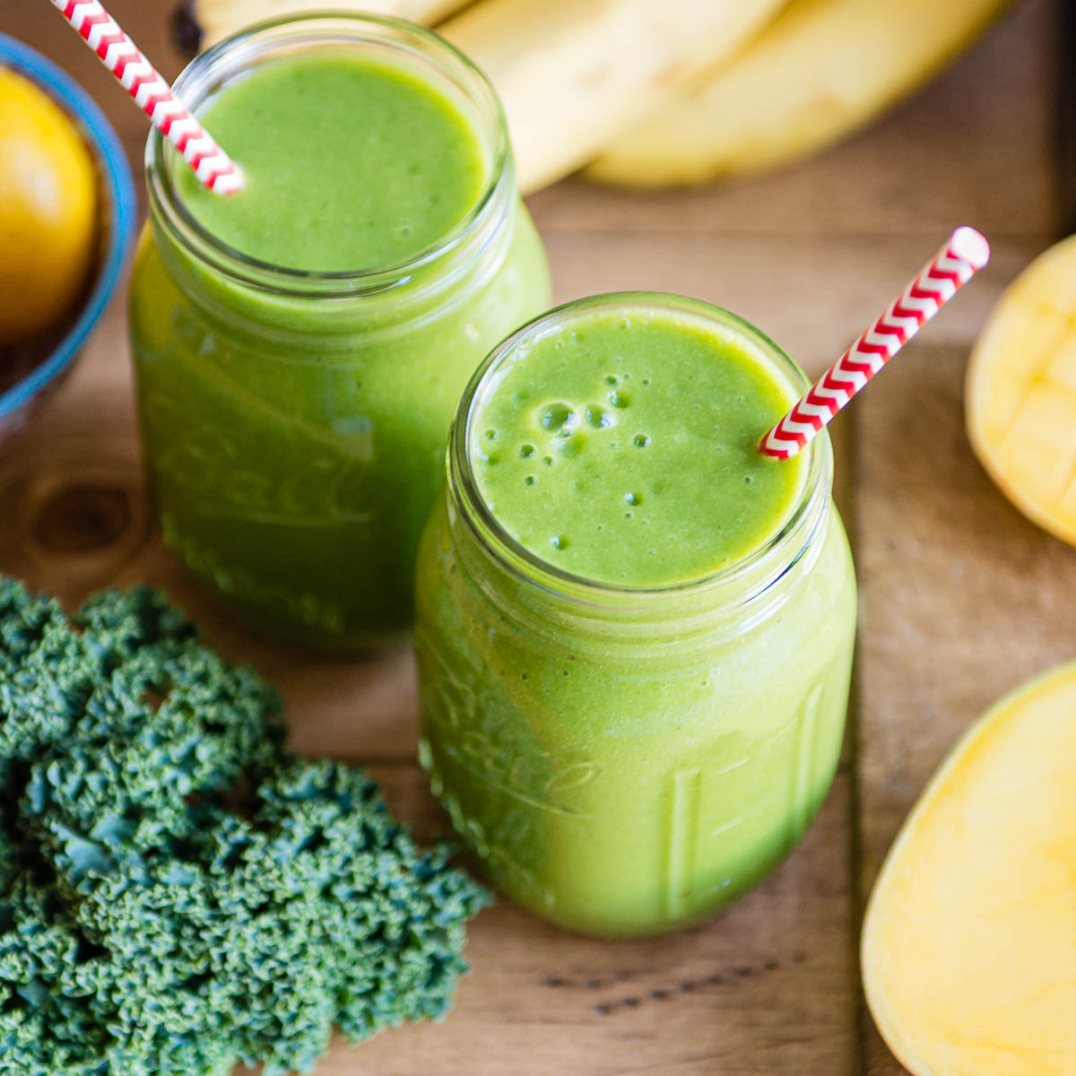 cleansing citrus smoothies in glass jars with paper straws.