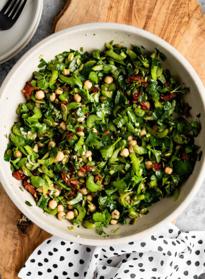 marinated celery salad in a bowl on a wooden plank as an easy summer meal idea.