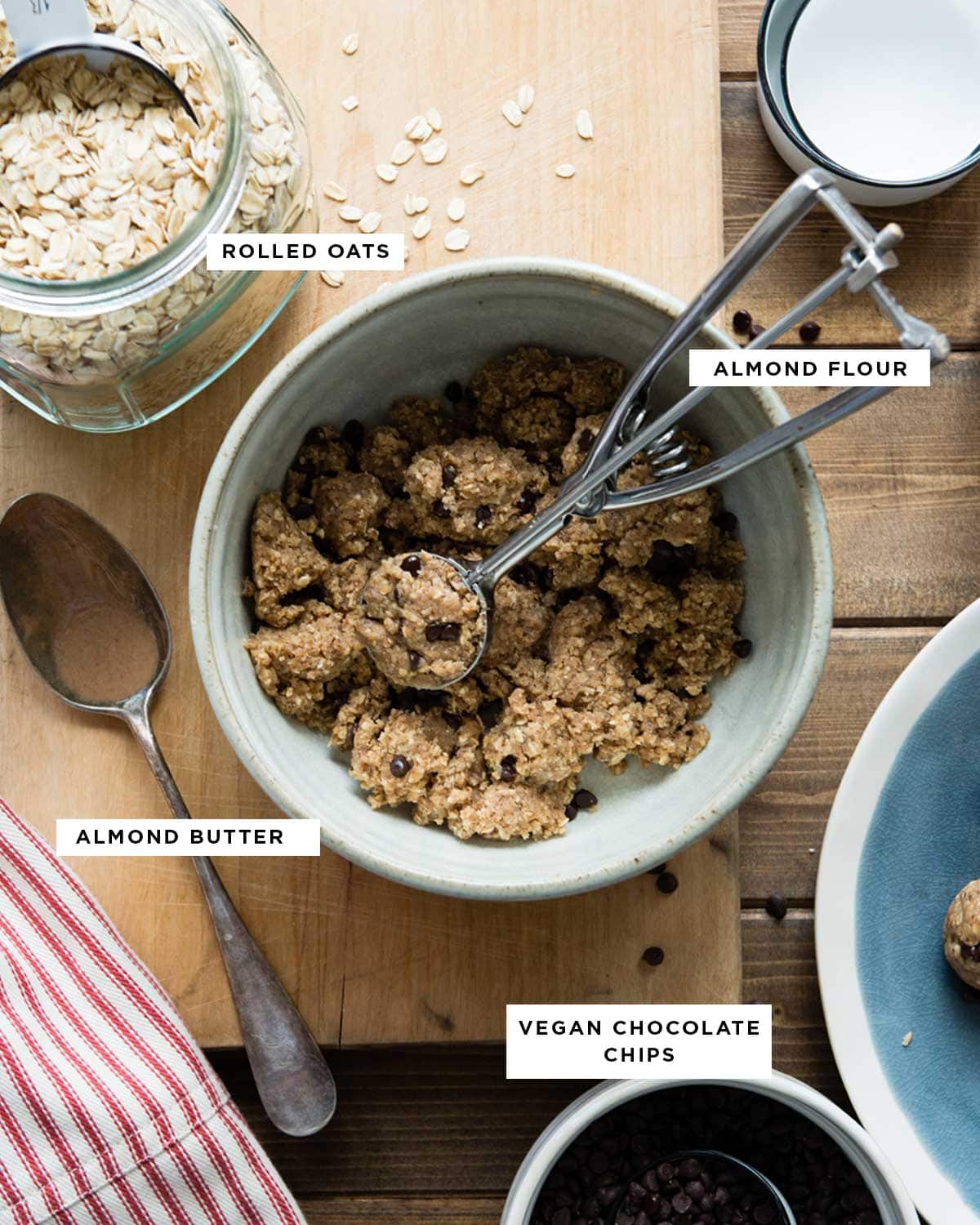 ingredients for energy balls recipe including rolled oats, almond flour, almond butter and vegan chocolate chips.