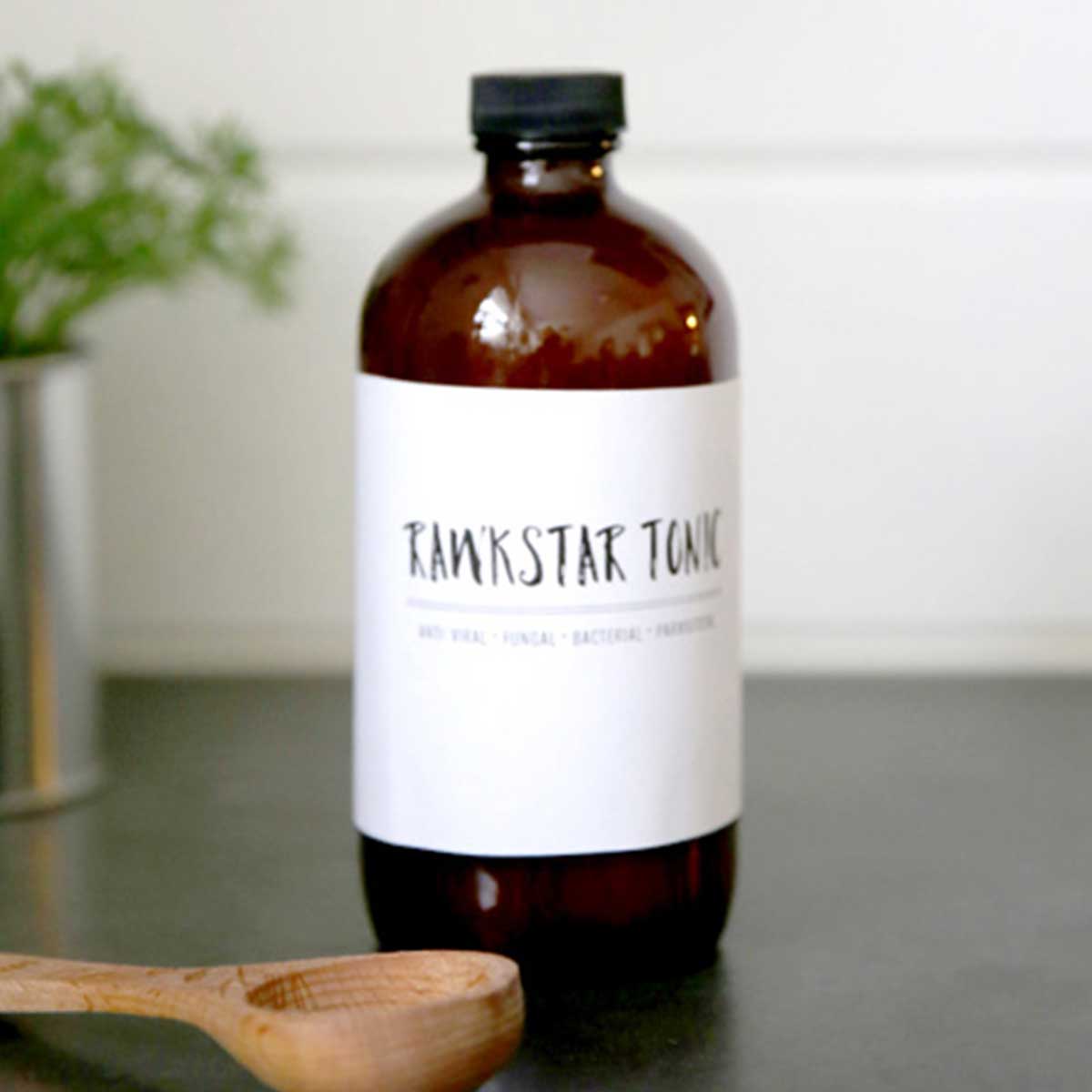 dark glass bottle with white label that says Rawkstar Tonic, a fire cider recipe