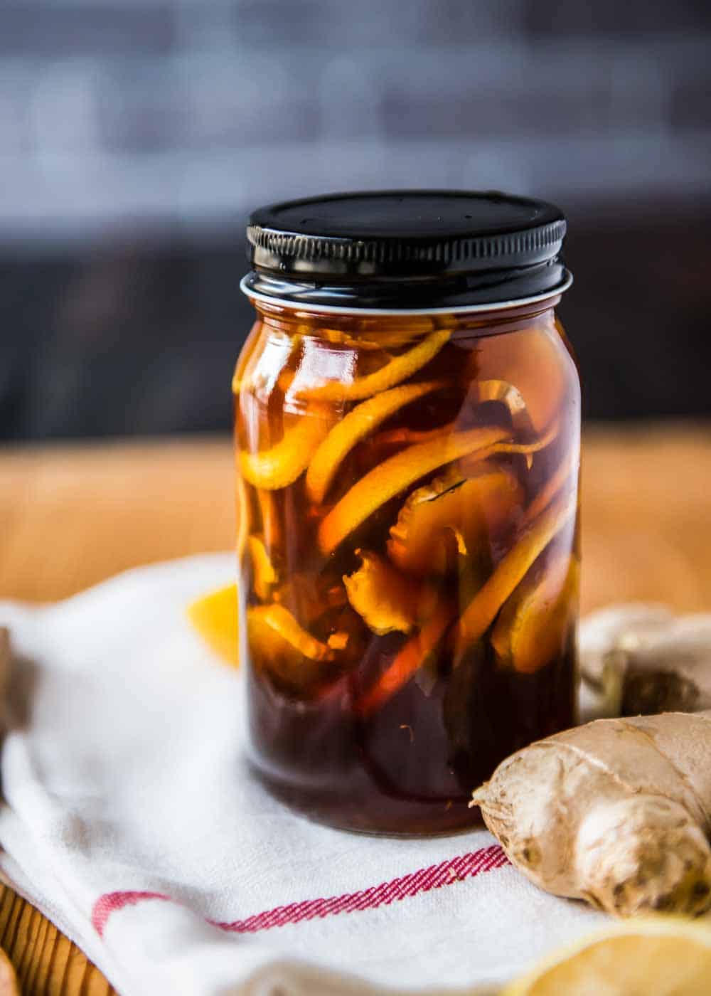 Large mason jar of Ginger Lemon Honey Tea.