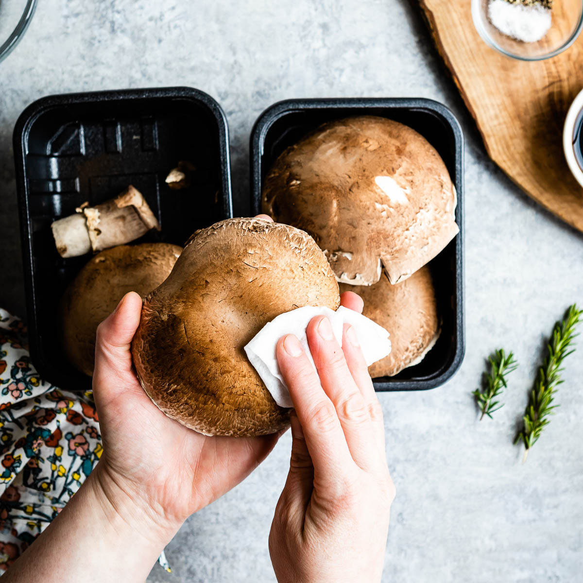 Patting Portobello mushrooms with damp cloth 