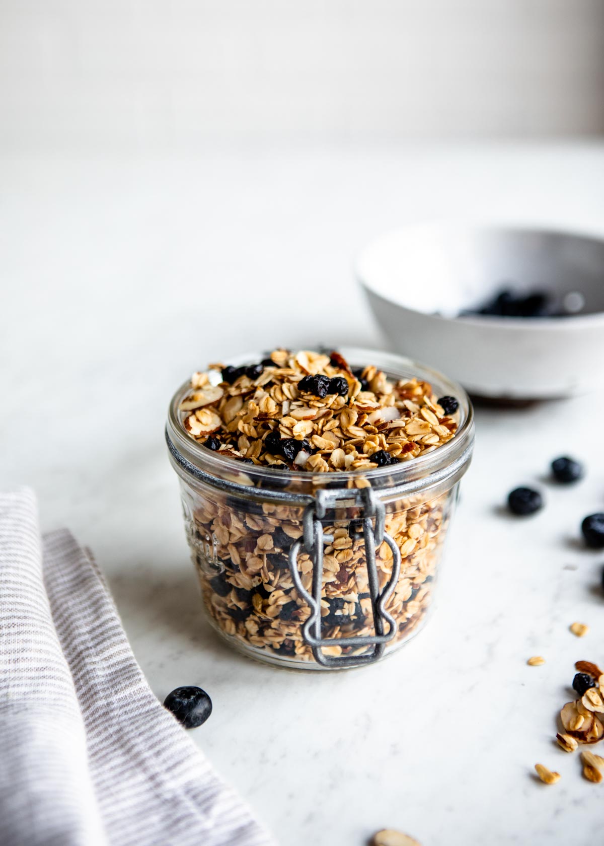 gluten-free granola with dried blueberries in a glass container.