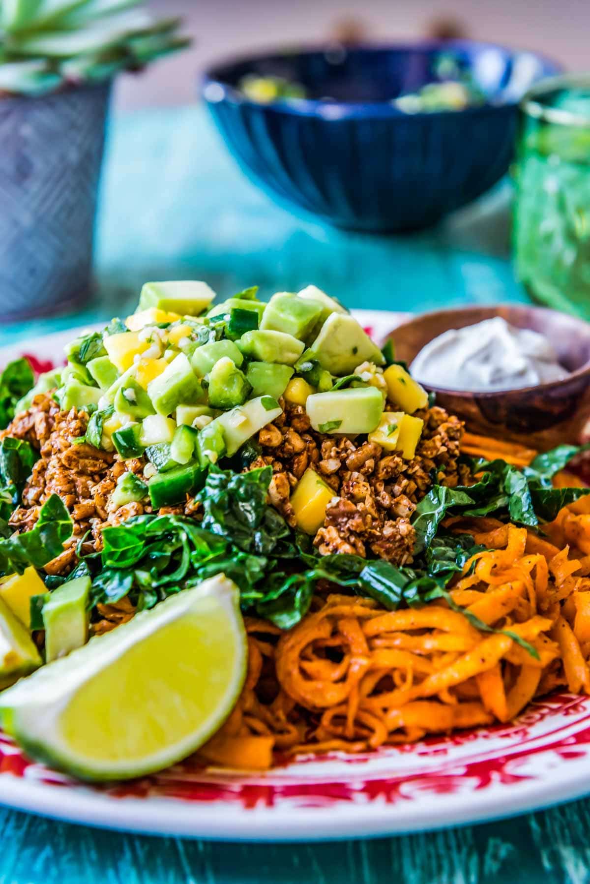 delicious salad loaded with kale, sweet potato, mango salsa, and walnut meat.