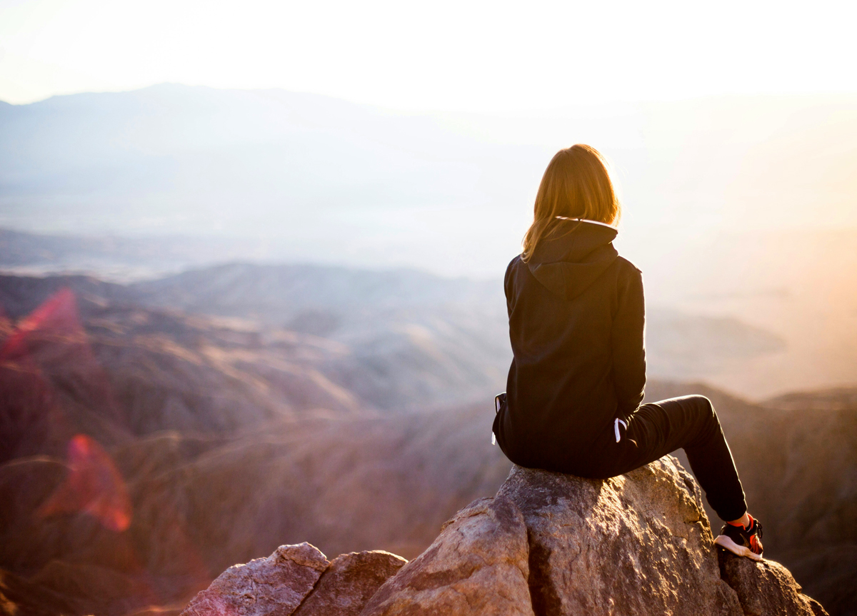 Fitness woman hiking mountains with lean muscles.