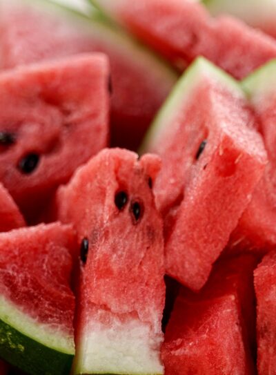 several slices of cut watermelon with the rind on.