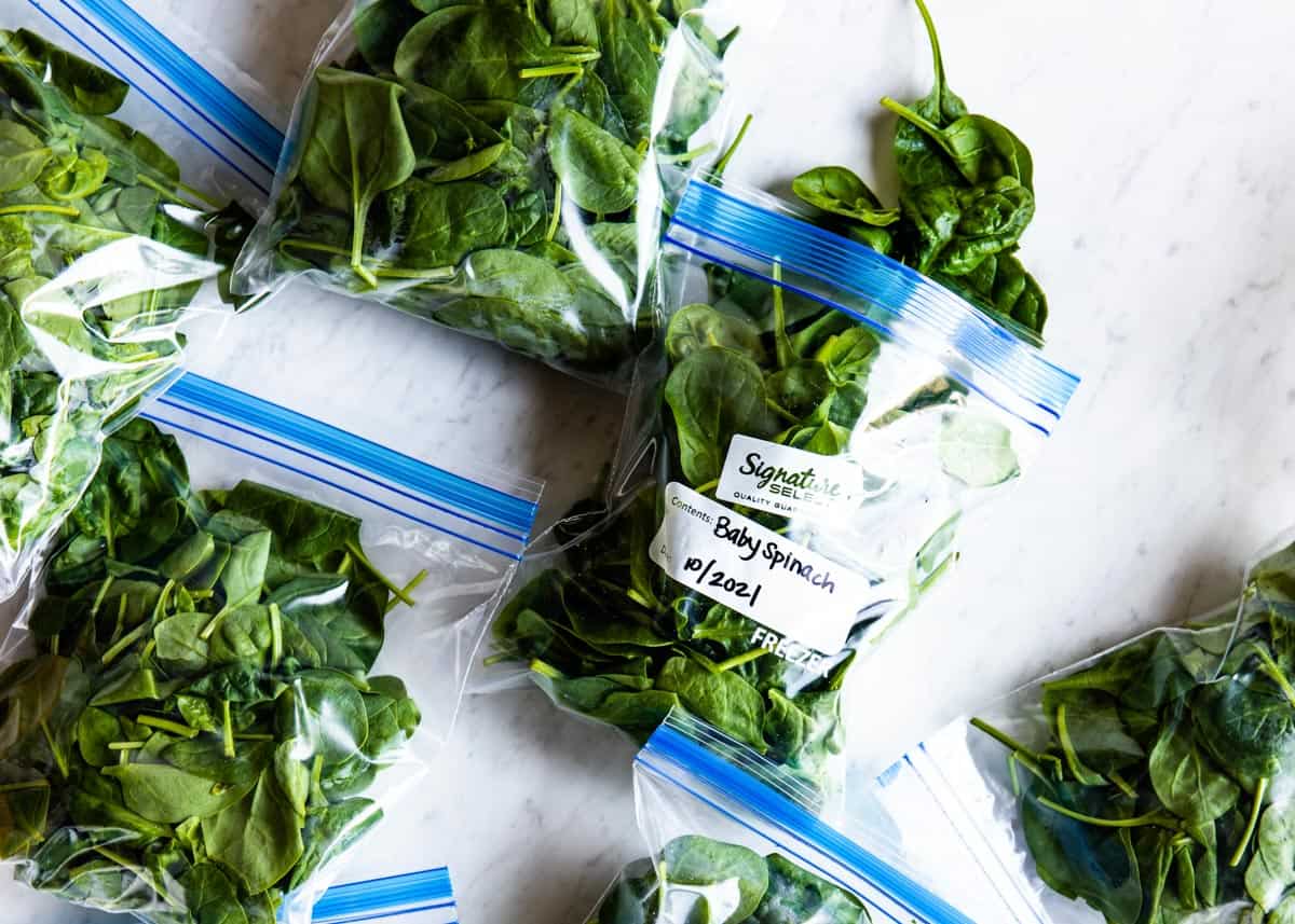 making bags of spinach to show how to freeze spinach.