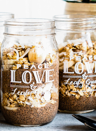 3 jars of chocolate chia pudding layered with fresh fruit and granola.