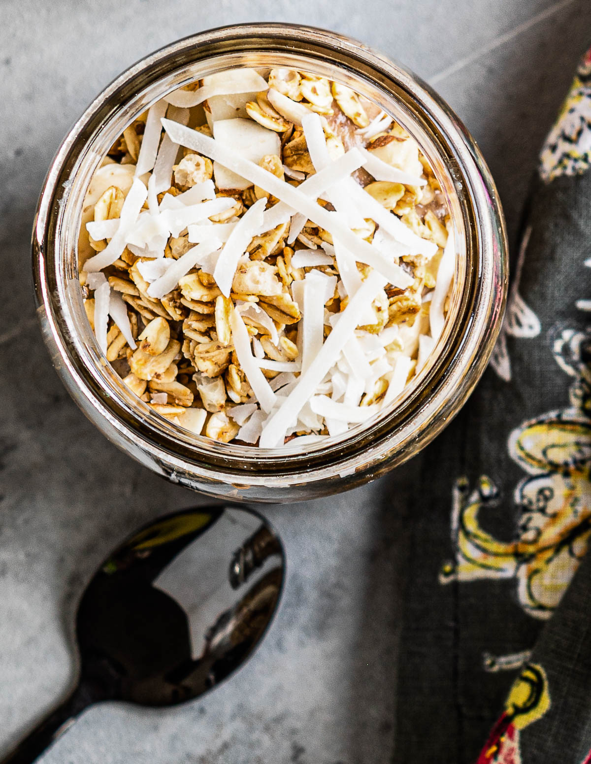 overnight chia pudding topped with granola and coconut flakes.