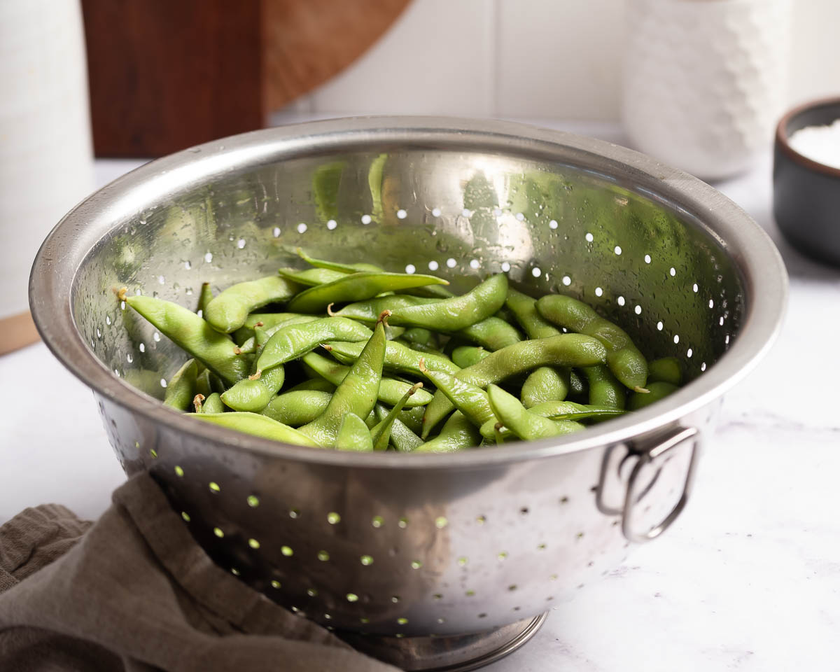 bean pods in a colander.