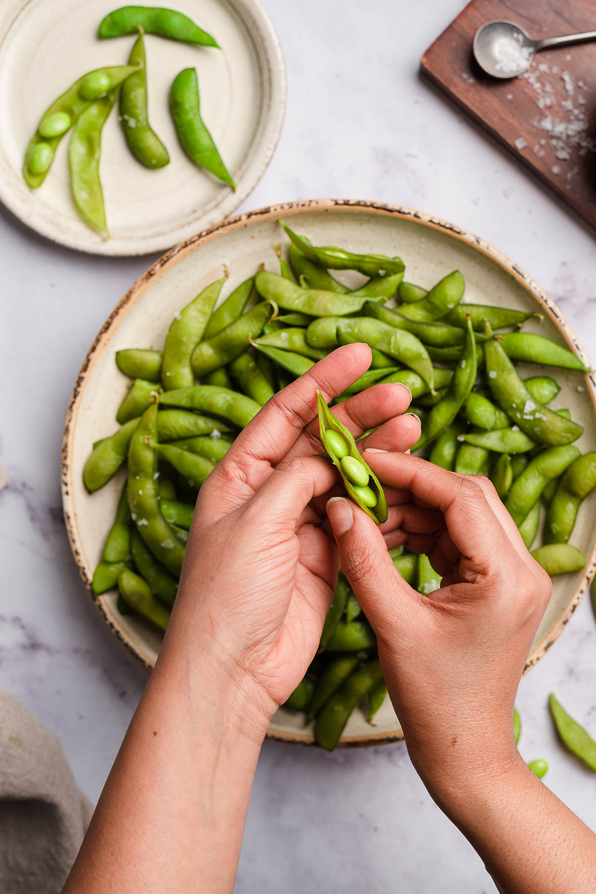 hand showing an open bean pod.