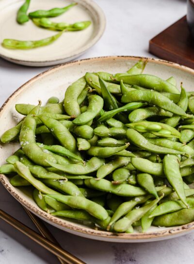 ceramic plate of boiled edamame.