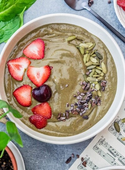 iron-rich smoothie bowl full of iron-rich ingredients and topped with fresh fruit and nuts.