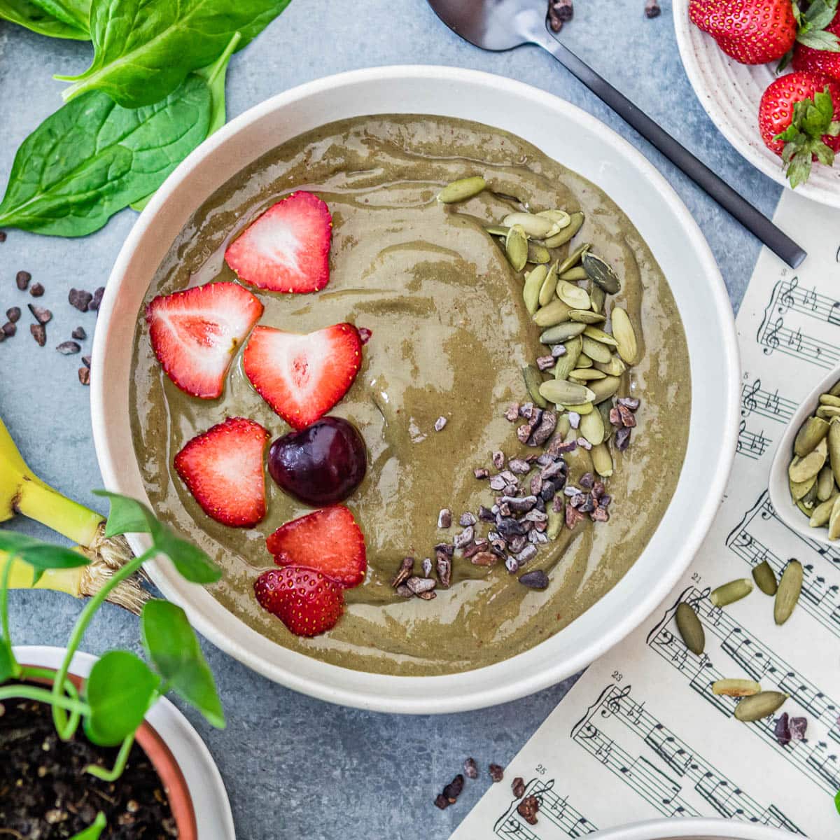 iron-rich smoothie bowl full of iron-rich ingredients and topped with fresh fruit and nuts.