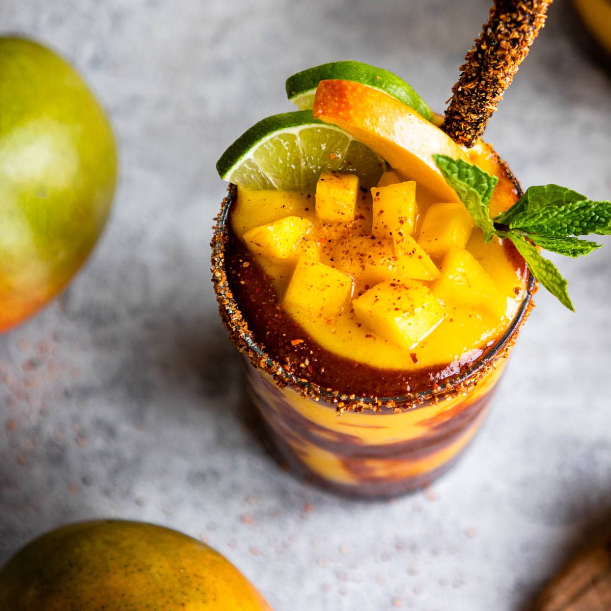 glasses of mangonada recipe with a chamoy sauce and tamarind straw.