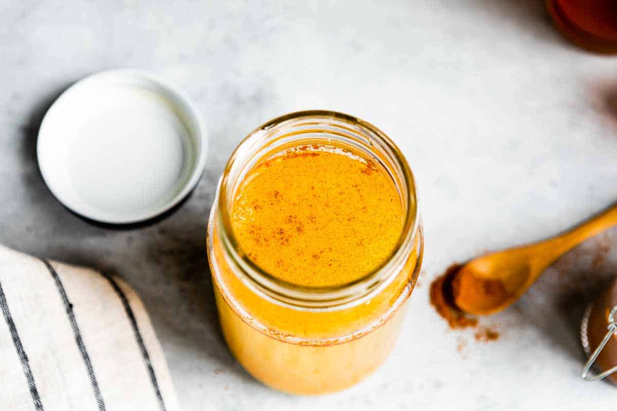 glass jar of metabolism tea topped with cayenne pepper.