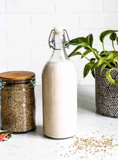 dairy-free smoothie milk in a glass jar next to a can of oats.