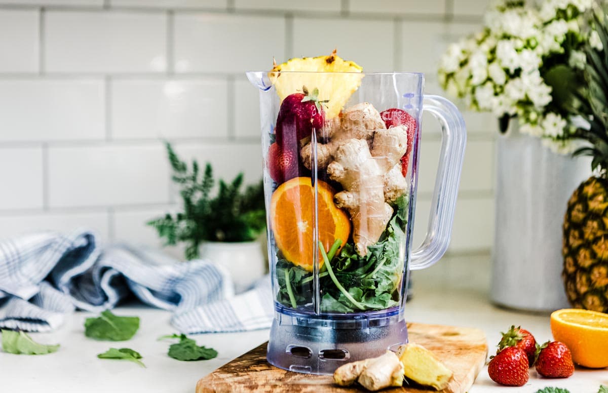 whole ingredients inside a blender container on a kitchen counter.