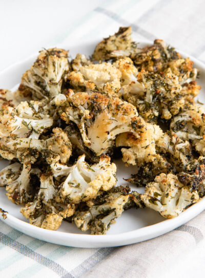 ranch cauliflower popcorn on a plate on a tea towel.