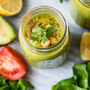 overhead photo of a savory protein shake in a glass jar topped with chickpeas and spices