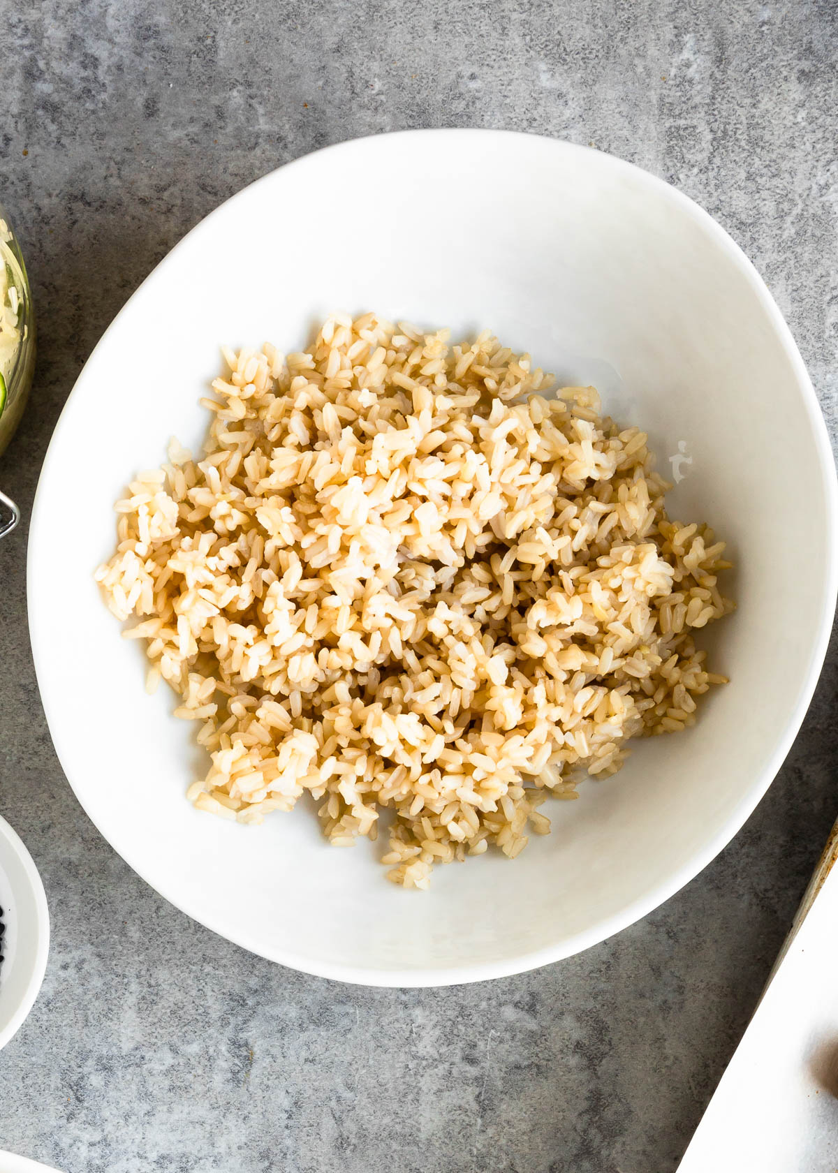 white bowl full of cooked brown rice.