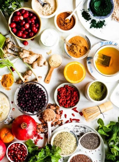 white counter full of bowls of different superfoods.