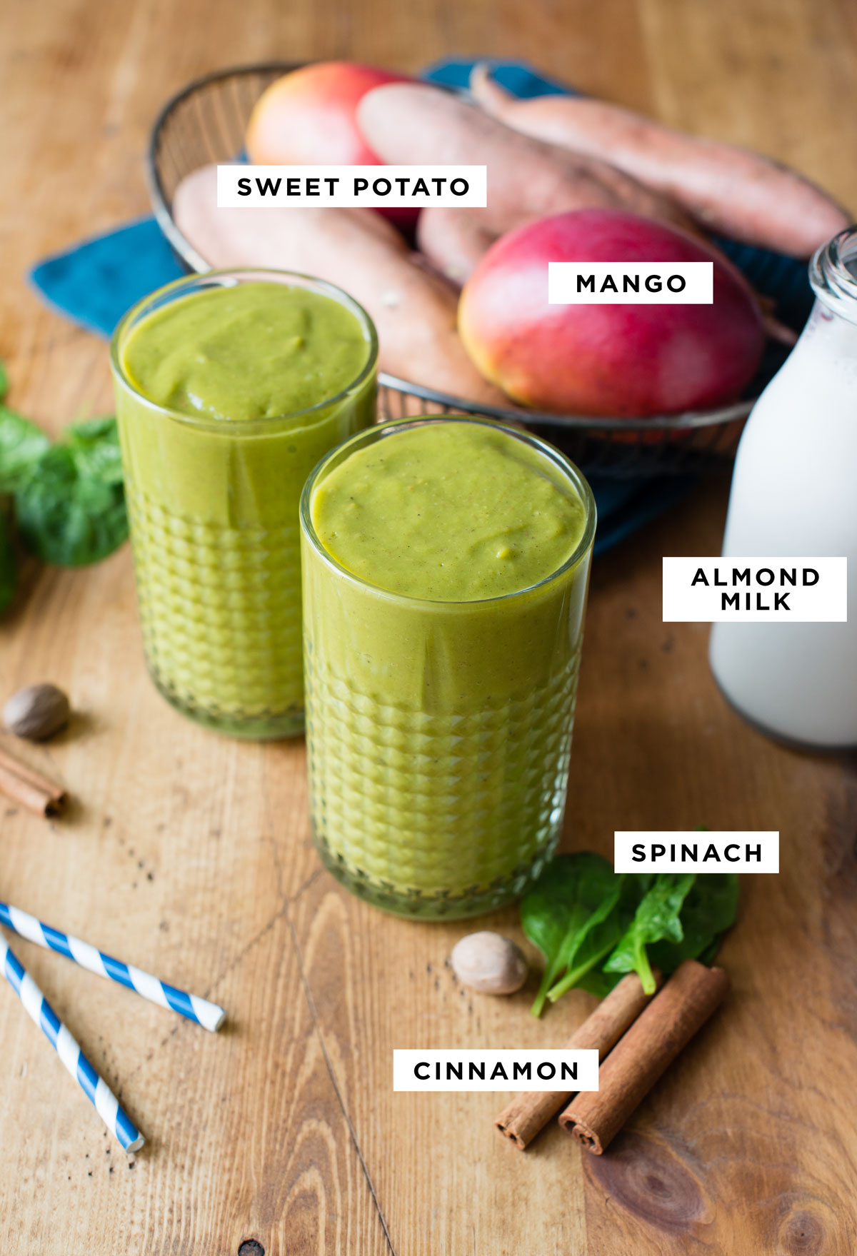 Ingredients for a sweet potato smoothie, including sweet potato, mango, almond milk, and cinnamon.