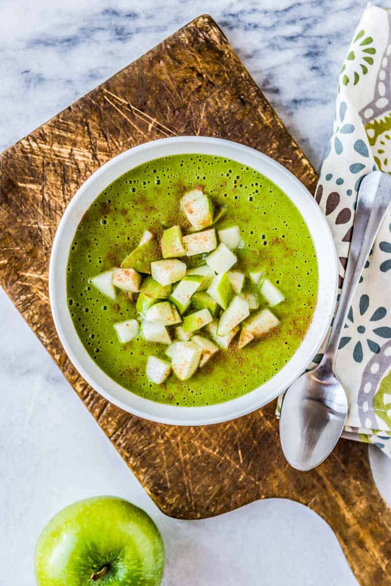 thick smoothie bowl recipe with apples in a white bowl.
