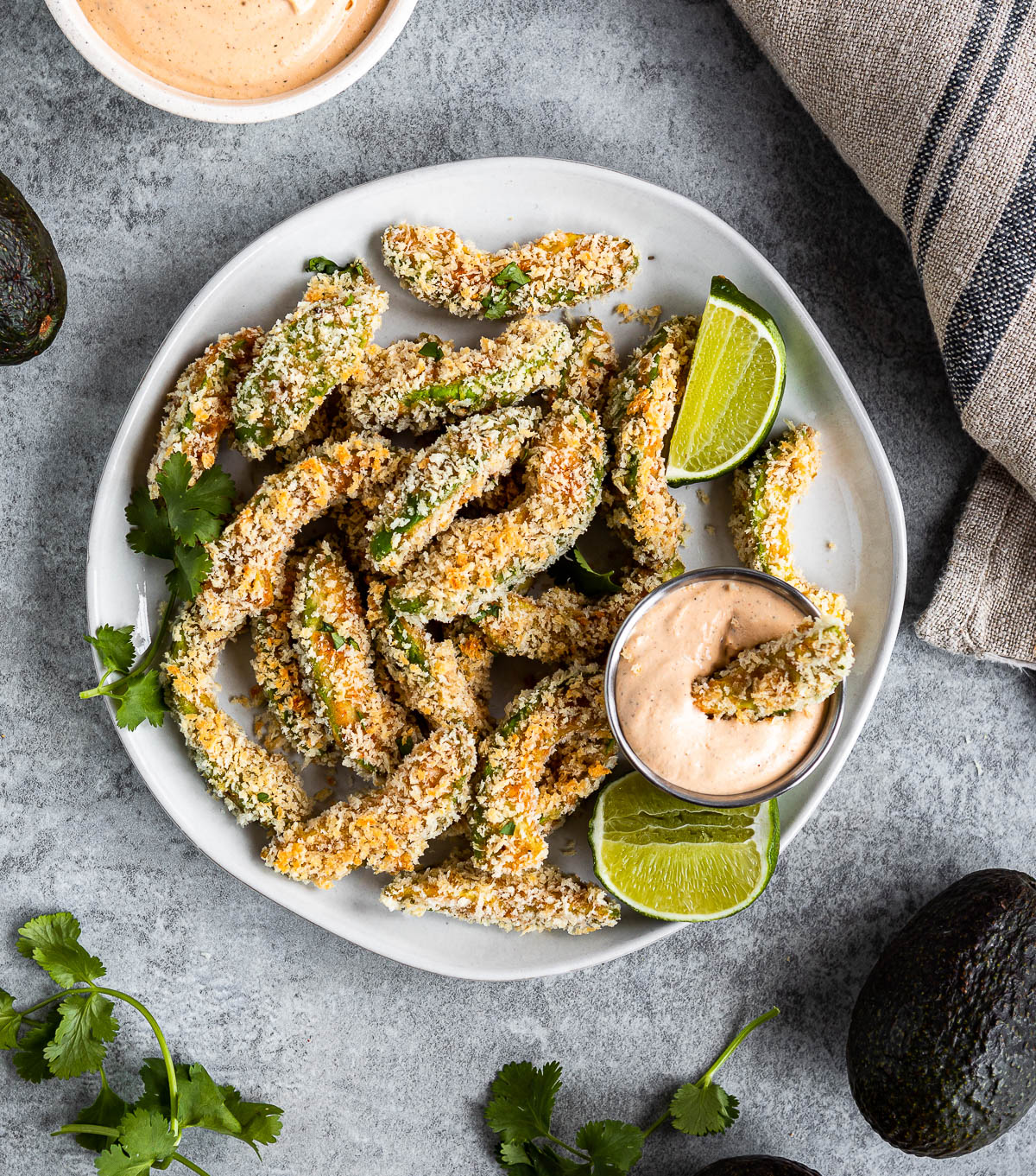 white plate of avocado fries and chipotle dipping sauce.