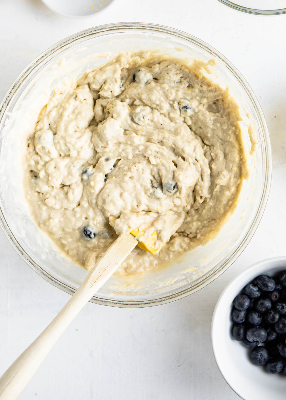 showing mixed batter in a bowl with a few lumps left.