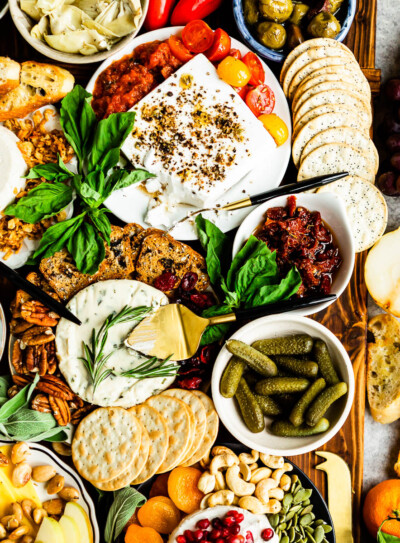 vegan charcuterie with plant based cheeses, fresh fruit, pickled veggies and an assortment of crackers.