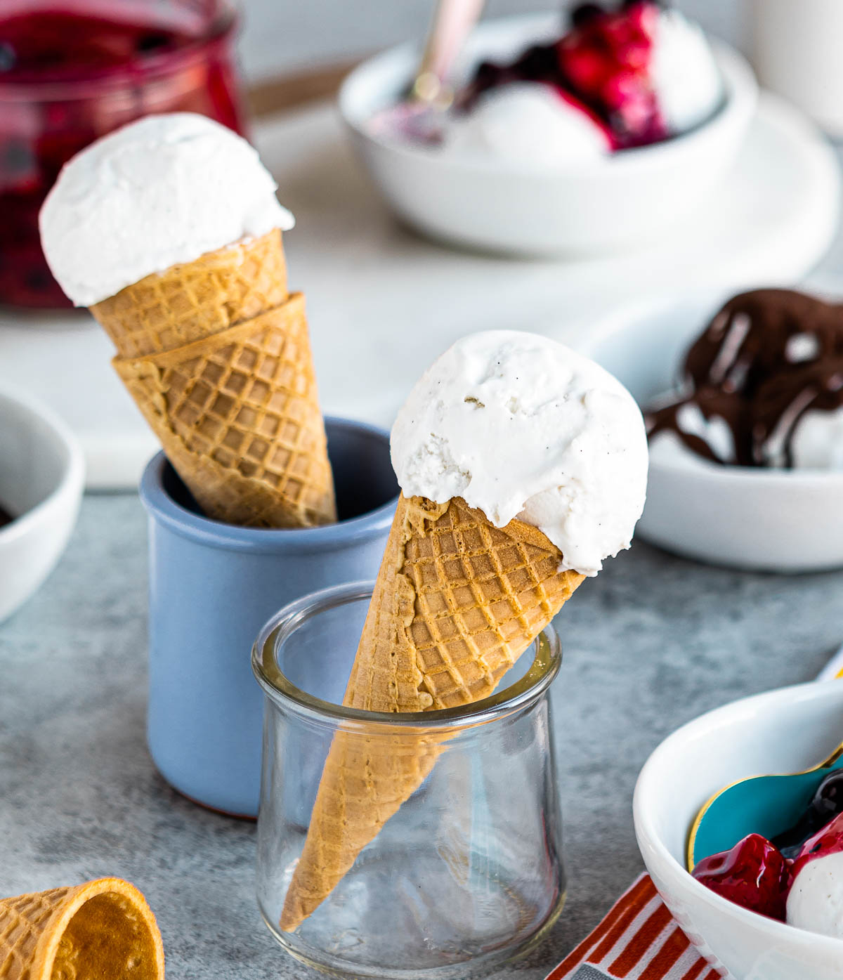 Vegan ice cream scooped into 2 sugar cones.