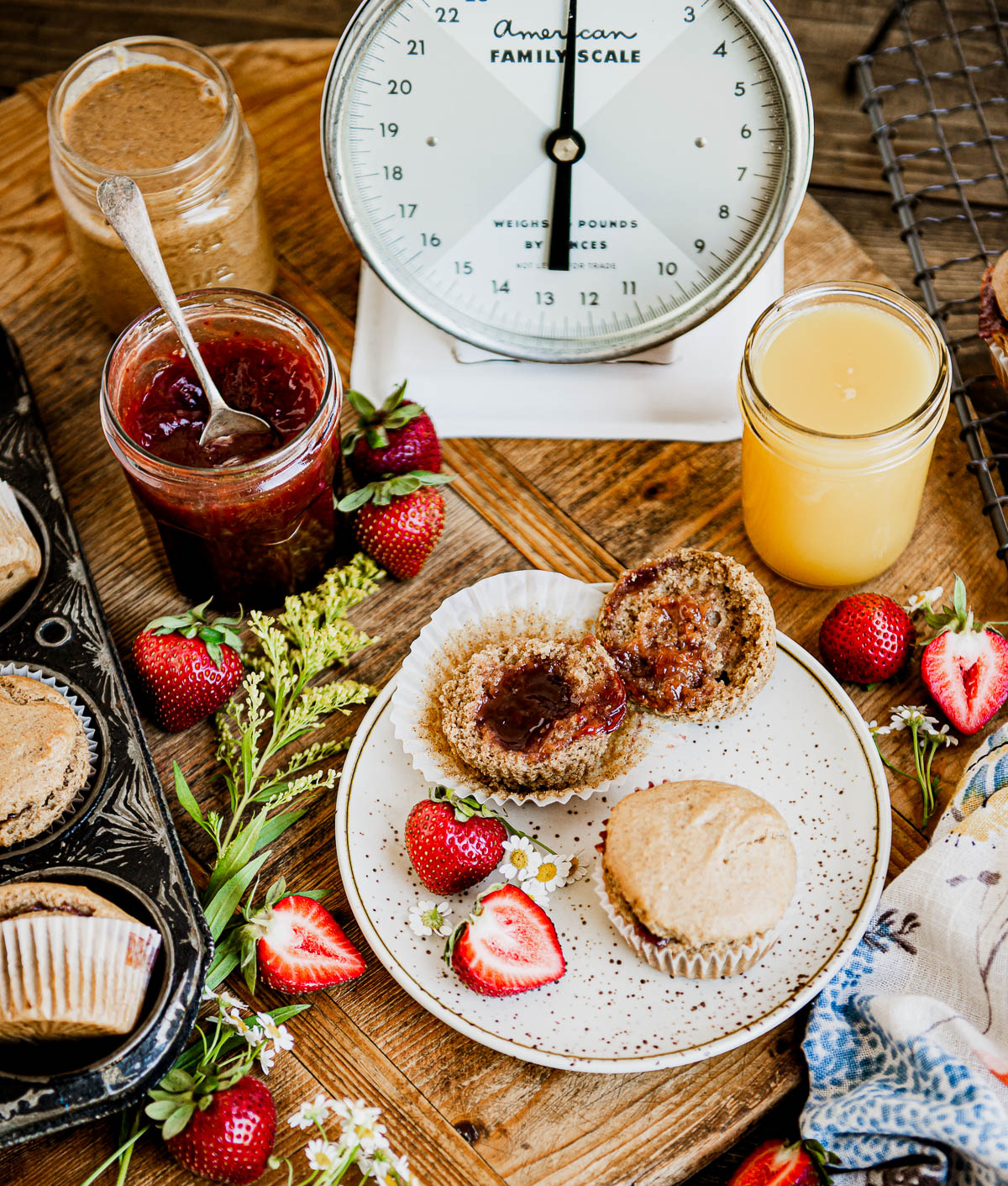 vegan muffins on a plate, one open to see jam filling.