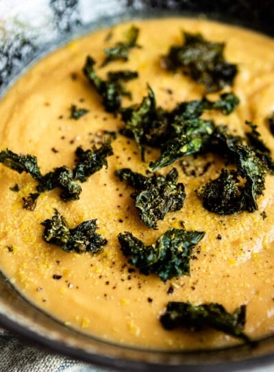 bowl of vegan potato soup topped with crunchy kale croutons.