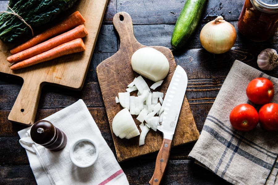 Ingredients for vegan tomato soup on cutting board.