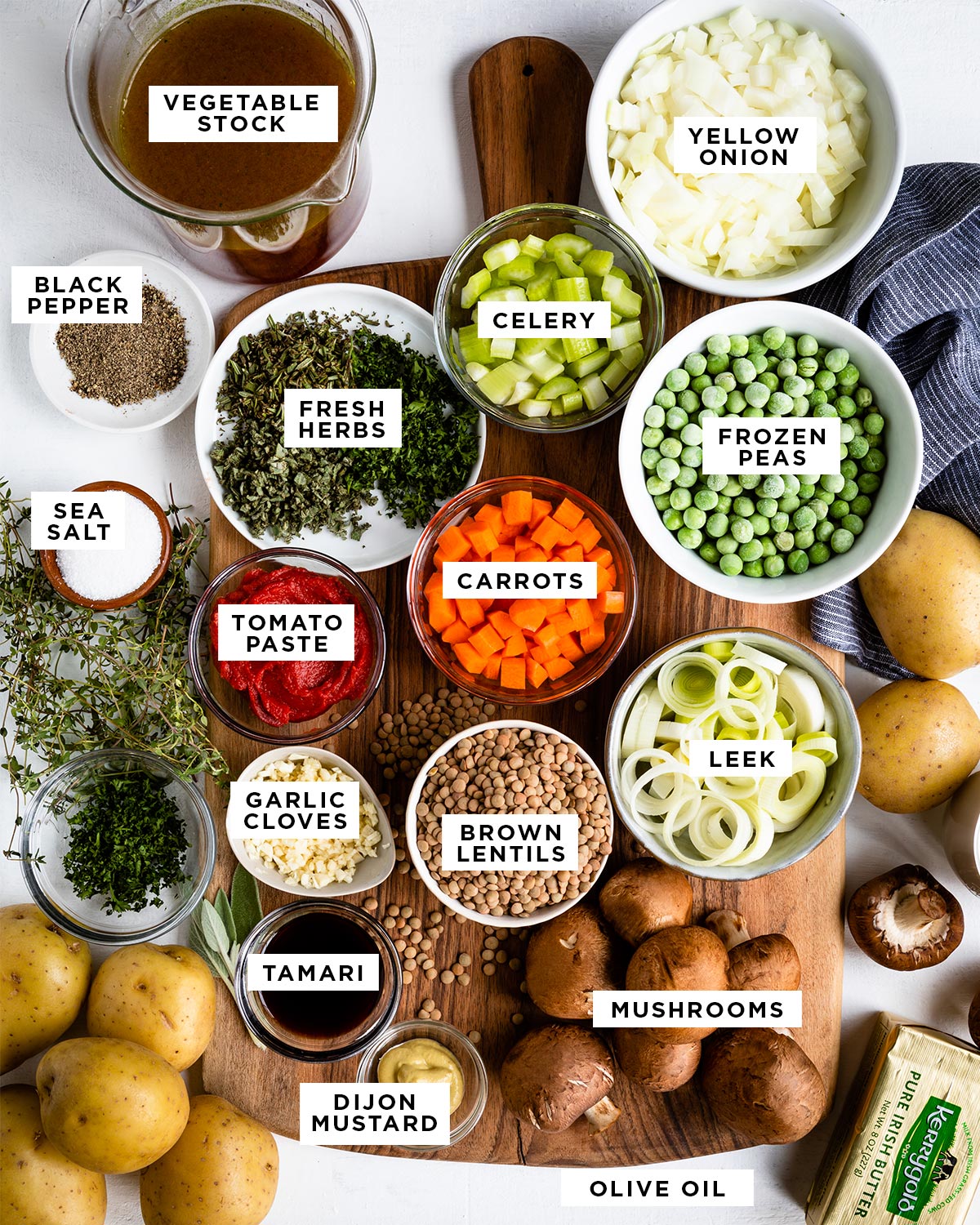 text boxes of ingredients overtop images for meatless shepherd's pie including vegetable stock, yellow onion, black pepper, fresh herbs, celery, frozen peas, sea salt, tomato paste, carrots, garlic cloves, brown lentils, leek, tamari, dijon mustard, mushrooms and olive oil.