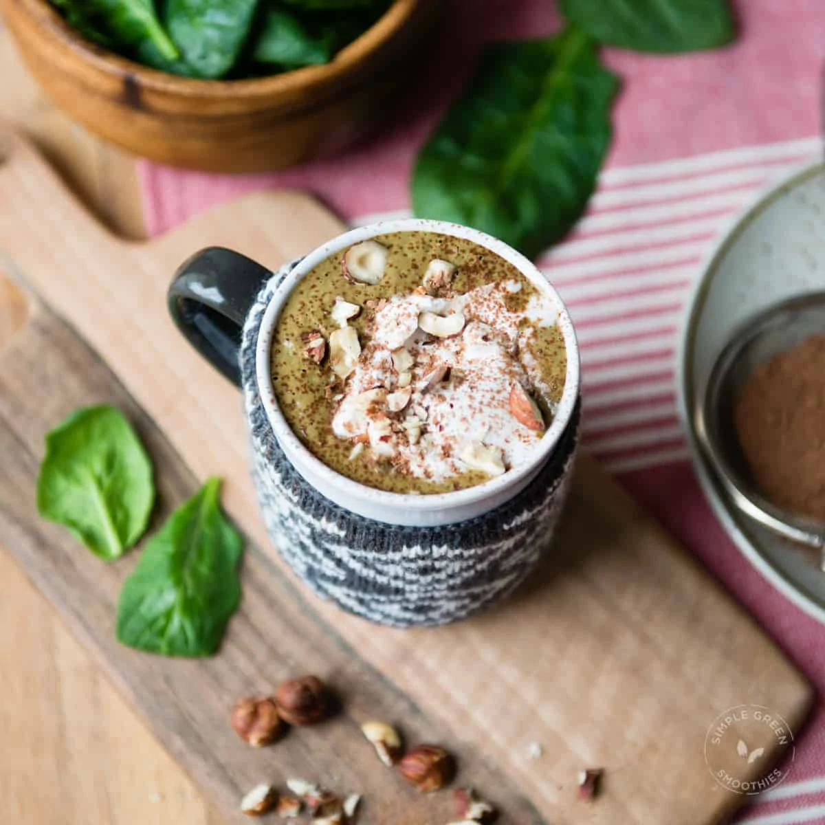 hot chocolate smoothie in mug with sweater wrap, topped with coconut whipped cream.